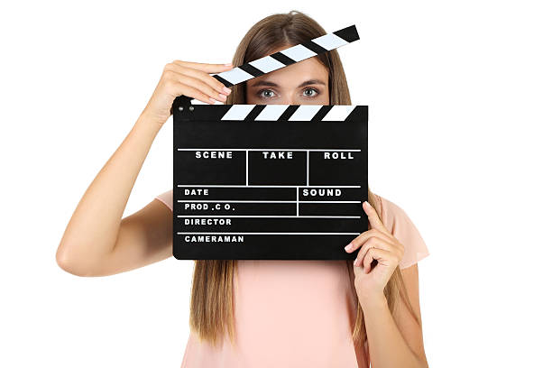 istock Young woman with black clapper board on white background 2208108932