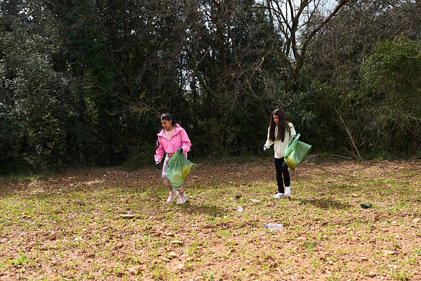 istock Two volunteers picking up trash in a forest 2208110560