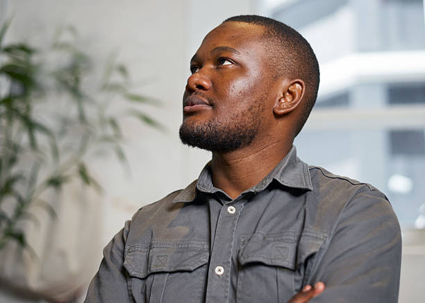 istock Thoughtful Young Man Looking Up in an Indoor Environment, Contemplating Ideas 2208110759