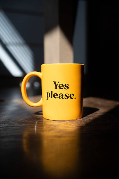 istock Bright yellow coffee mug with the phrase “Yes please.” 2208110912