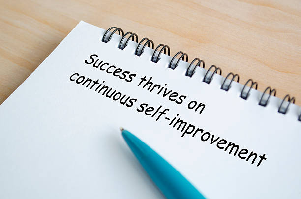 istock Success thrives on continuous self improvement text on white notepad. Success and inspirational motivation 2208114629