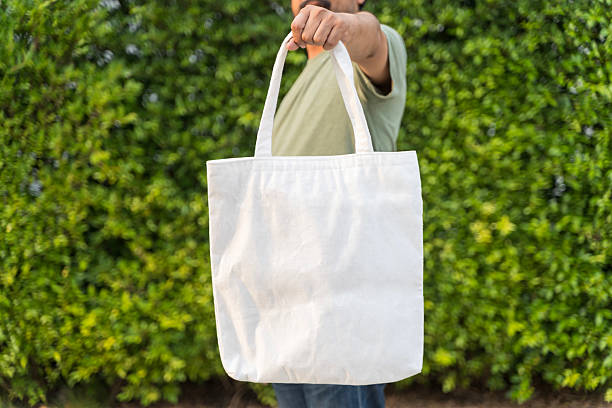 istock Zero waste lifestyle concept. Man is holding bag canvas fabric for mockup blank template. 2208123930