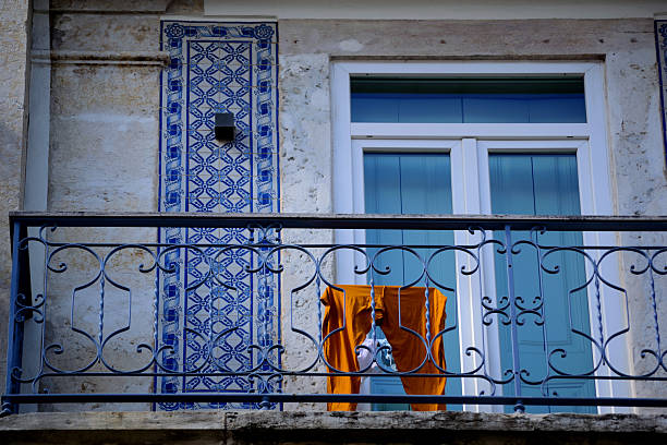 Typical facade of the buildings of the beautiful city of Porto, Portugal. With its windows, balconies and hanging clothes. Next to the Douro river.