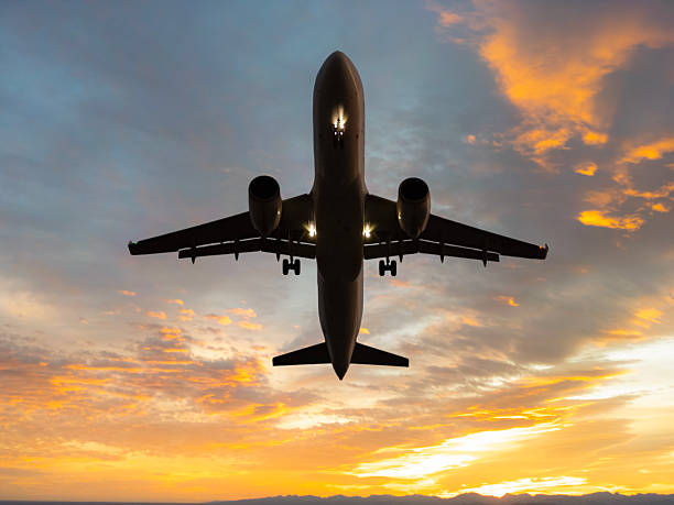istock Passenger plane taking off over the city at sunset. 2208124921
