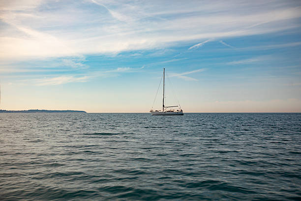 Sailboat on Horizon over the Sea.