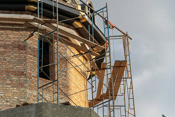 istock Workers are engaged in construction activities on a historic building, utilizing scaffolding and wooden planks to access the upper sections of the structure 2208132382