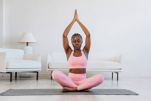 istock Woman is doing yoga at home 2208132451