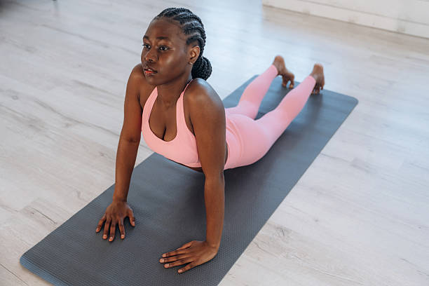 istock Spine exercise. Woman is doing yoga at home 2208132455