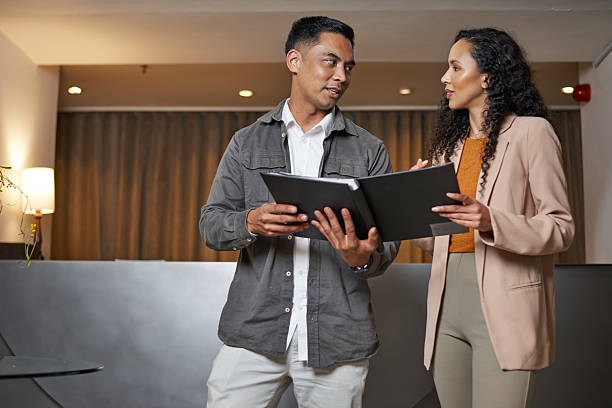 Professionals Collaborating in a Hotel Lobby for a Business Presentation