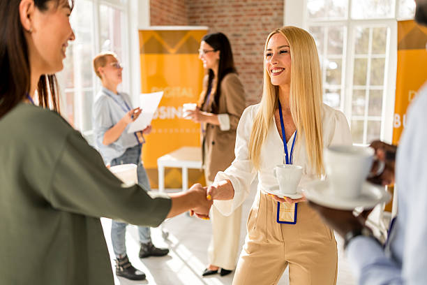 istock Business professionals engage in networking at a conference in a modern convention center 2208135845