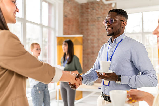 istock Business professionals networking at a conference in a modern convention center promoting collaboration and learning among diverse groups 2208137052