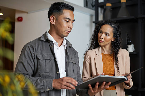 istock Two Professionals Engaged in a Discussion in a Modern Office Setting 2208140204