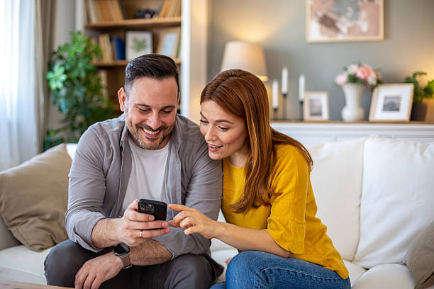 istock Couple enjoying video content on mobile phone 2208141411
