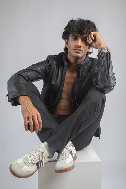 istock Man in jacket and sneakers sitting on white background 2208142126