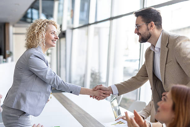 istock Engaging Business Moment with Shaking Hands and Smiles 2208142376