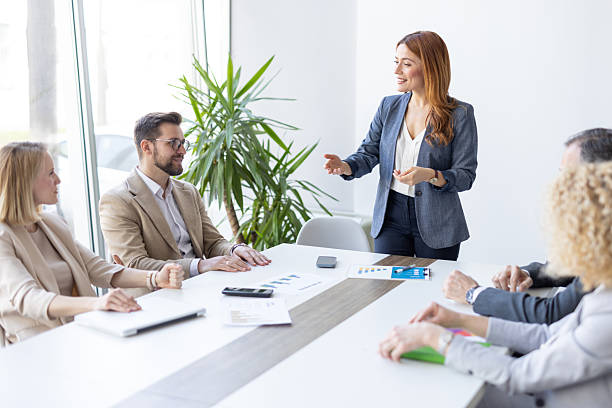 istock Businesswoman Presenting Ideas to Engaged Team in Office 2208142385