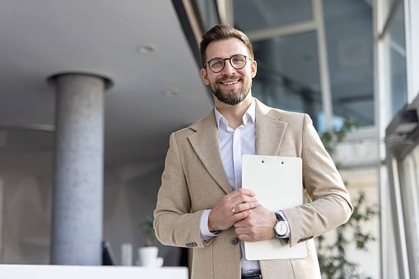 istock Professional man smiling in modern office setting indoors 2208142416