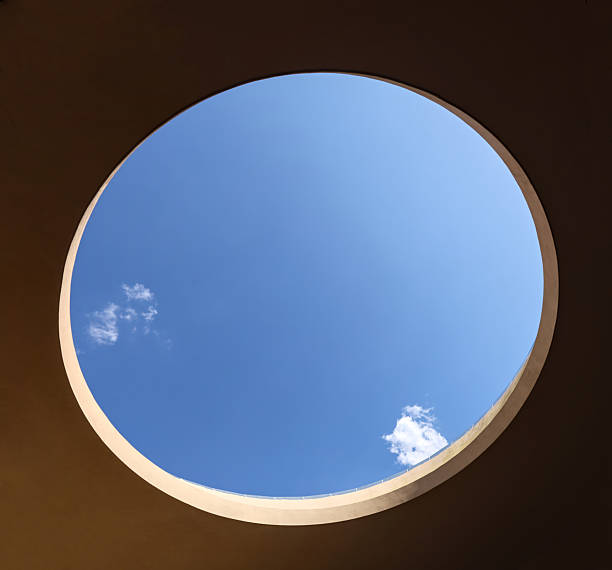 istock large open circular opening in a building with blue sky and clouds visible (modern architecture skylight) mexico window to outdoors 2208142471
