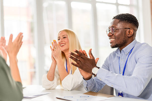 istock Engaging discussions at a business conference with enthusiastic participants in a modern conference space 2208142829