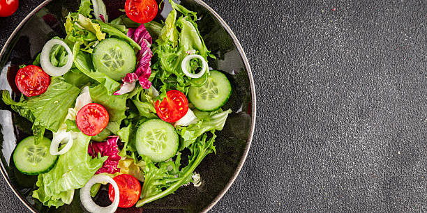 istock Vegetable salad tomato, cucumber, lettuce, green leaf lettuce, onion appetizer vegetable dish fresh gourmet food background rustic food top view copy space keto and paleo diet vegetarian vegan food 2208143023