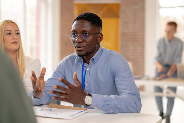 istock Engaging discussions at a corporate training session in a convention center among diverse business professionals 2208143094