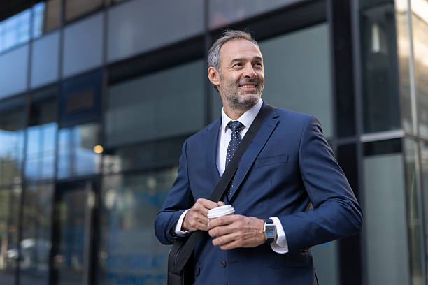 istock Professional man smiling with coffee in business attire. 2208143993