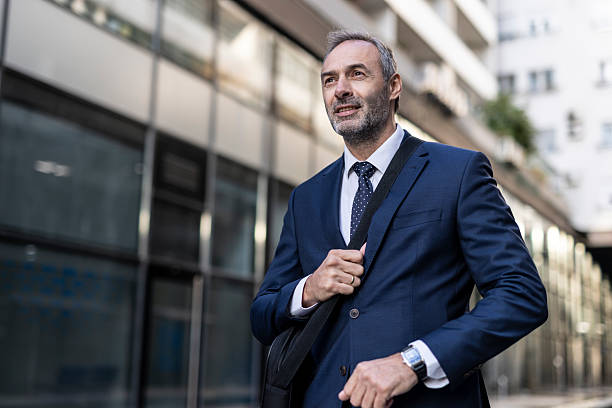 istock Confident businessman walking with a bag and a drink 2208144002