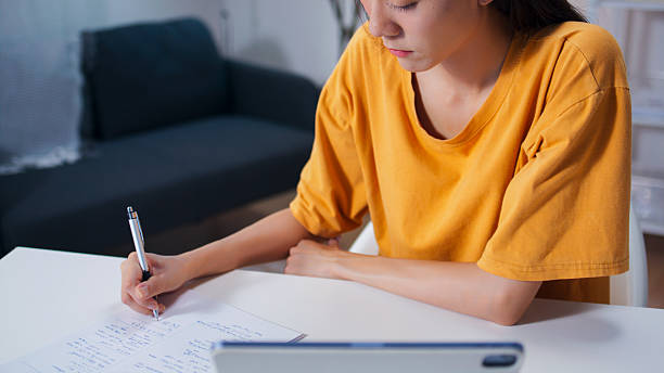 istock Asian woman using laptop computer studying online class webinar at home 2208144542