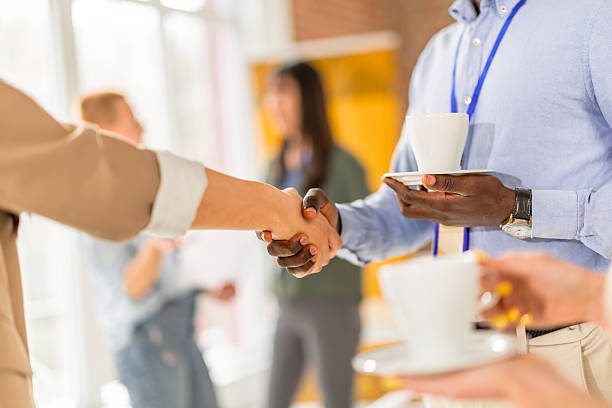 istock Networking and collaboration among diverse professionals at a business conference in a convention center setting 2208144701