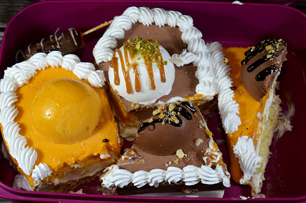 istock Ice cream cake of assorted and various flavors with a sponge cake layer within ice cream and whipped cream 2208145034