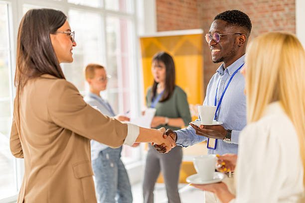 istock Networking and collaboration at a business conference with diverse professionals engaged in discussion 2208146029