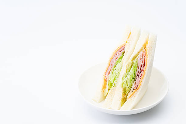 Delicious-looking ham, cheese, and lettuce sandwich on a plate
