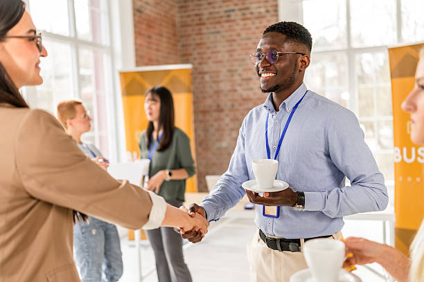 istock Networking at a business conference in a convention center with diverse professionals engaging in conversation 2208146902