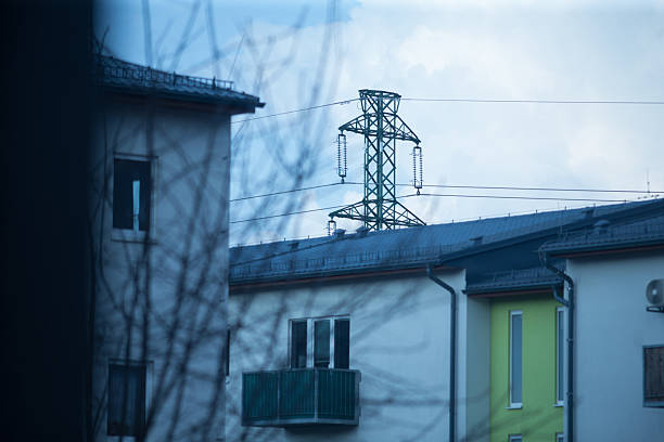 A hazy, unclear image depicts a building set against the backdrop of an overhead power line, creating an intriguing visual juxtaposition