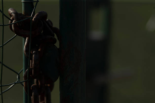 istock A Rusty Chain and Lock Sitting on a Fence in a Soft Focus Background 2208151665