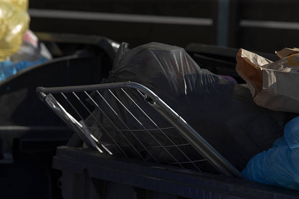 istock A trash can completely filled with a large amount of trash 2208151896