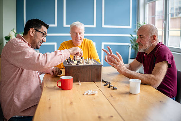 istock Military veterans enjoy a chess game at home, bonding over strategy and laughter during a casual game night 2208152391