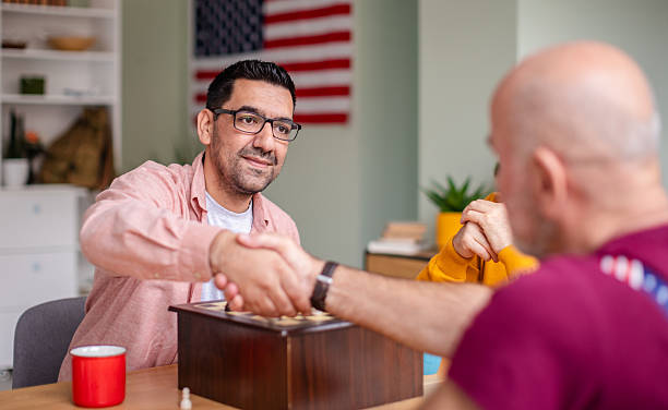 istock Senior military veterans enjoying a friendly chess game in a cozy home environment while sharing moments of strategy and camaraderie 2208152541