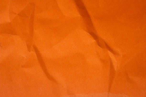 Abstract crumpled orange paper background creased texture