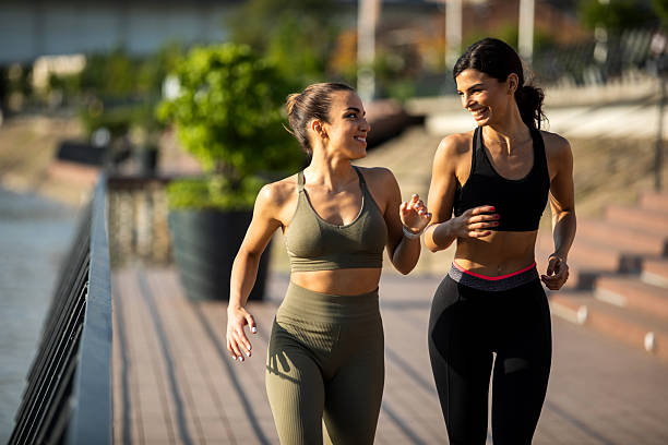 istock Young female runners  at the river dock 2208155099