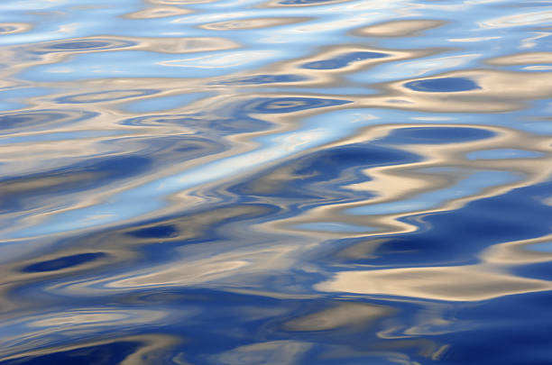 The wind blows up the river surface, producing different wave patterns