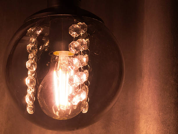 istock Retro ball-shaped lamp against dark curtains. 2208156560