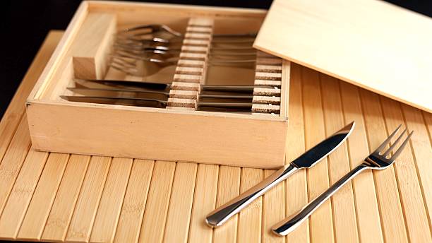 istock Sleek silver knives and forks in wooden storage box, highlighting sustainable dining tools. Perfect for eco-friendly kitchens focused on aesthetics, durability, and stylish simplicity in tableware. 2208156853