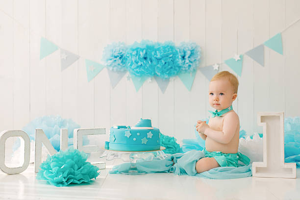 A one-year-old boy tries his first birthday cake