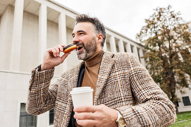 istock Busy Entrepreneur Enjoying a Quick Snack on the Go 2208159002