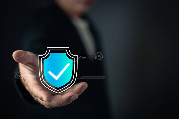 istock A person extends their hand, showcasing a glowing blue shield icon with a checkmark, symbolizing cyber security, data protection, trust, and secure digital systems in a modern technological context. 2208159710