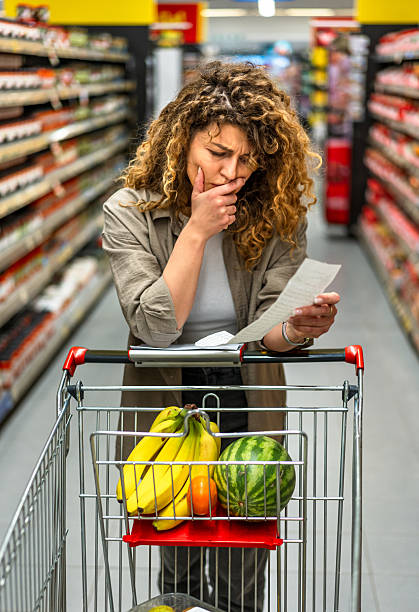 istock Woman feeling concerned about grocery prices on the bill 2208160568
