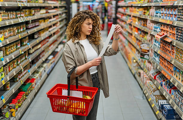 istock Woman feeling concerned about grocery prices on the bill 2208160605
