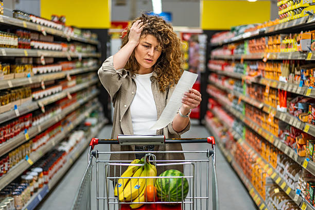 istock Woman feeling concerned about grocery prices on the bill 2208161248