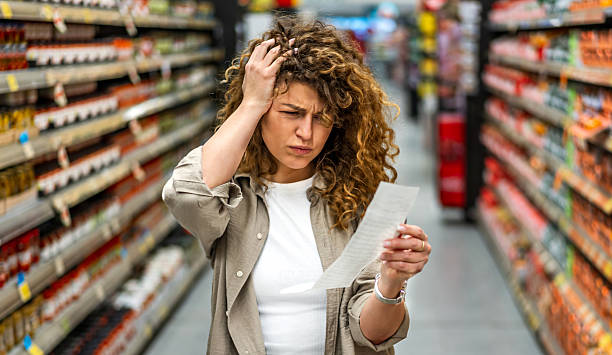 istock Woman feeling concerned about grocery prices on the bill 2208161262